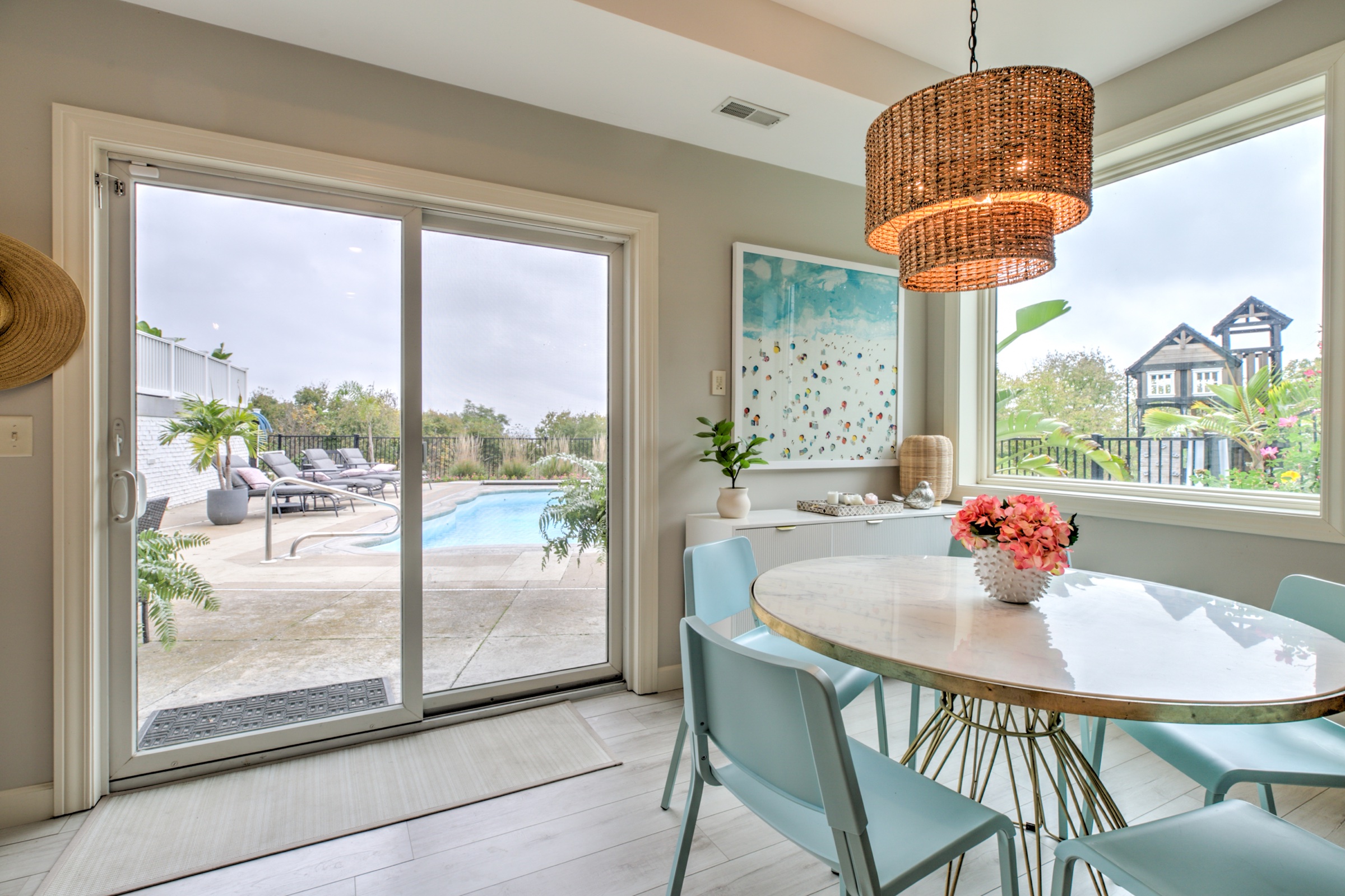 Breakfast area with a woven pendant and direct access to the swimming pool terrace