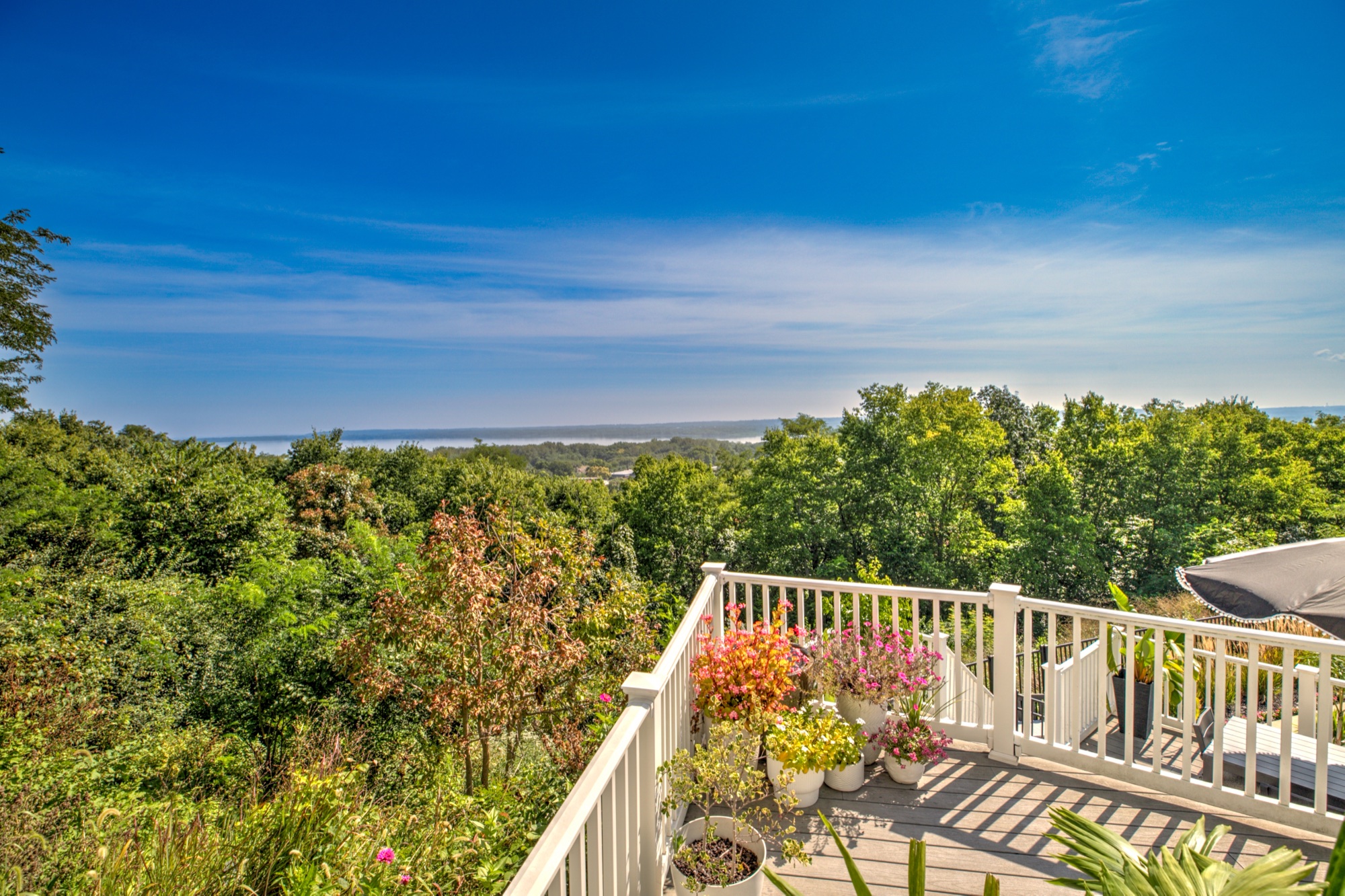 Elevated deck overlooking a wooded bluff and the Illinois River Valley
